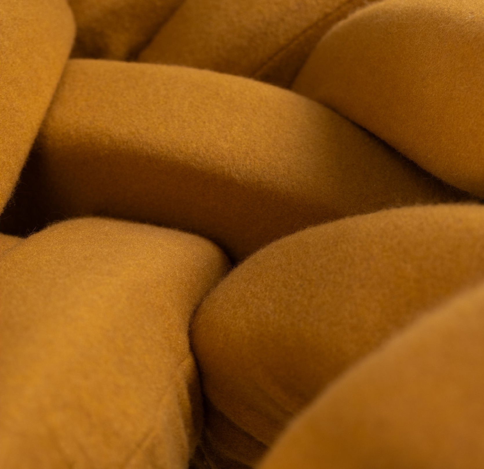 Close-up of WIG's hand-sewn ochre fabric-tube upholstery